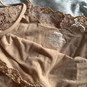 Skims fits everybody corded lace onesie clay